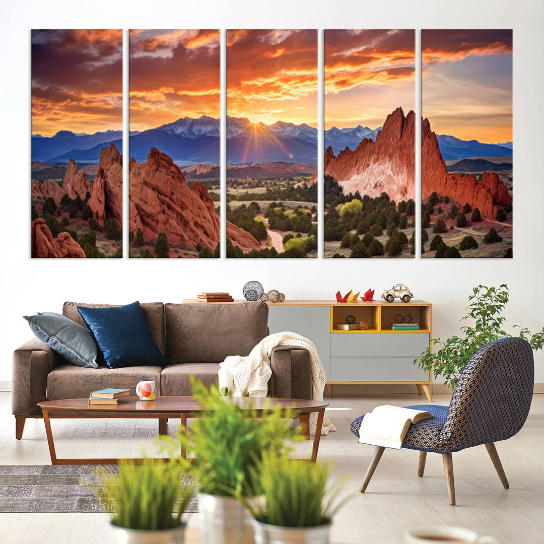 A vibrant sunset over the Rocky Mountains with red rocks.