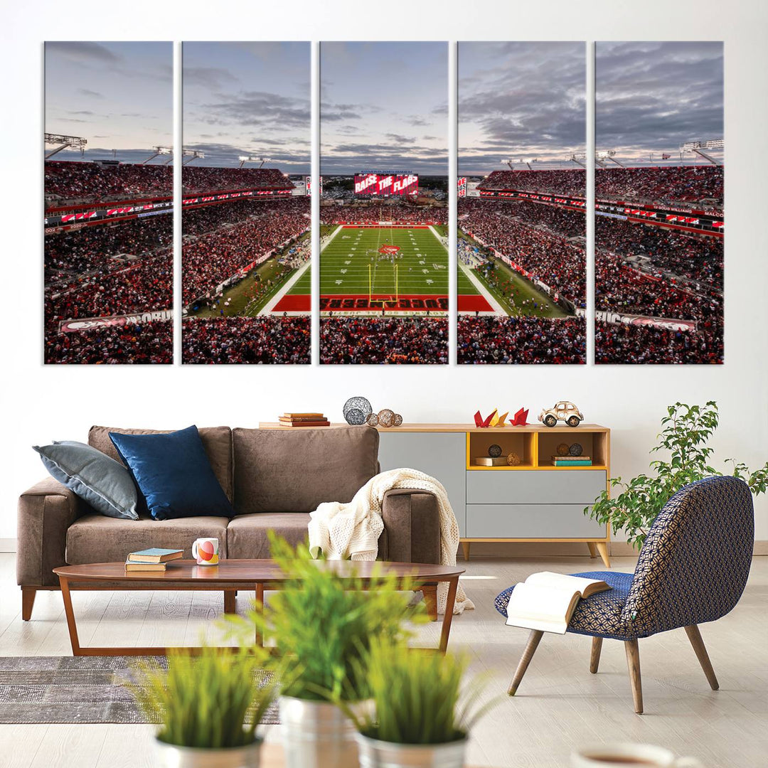 The wall art captures a stunning scene of Raymond James Stadium bathed in the warm hues of sunset. The sky, filled with clouds, provides a dramatic contrast to the vibrant lighting on the field, encapsulating the dynamic energy of a football game.