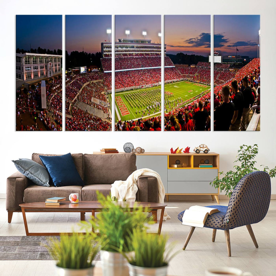 A print of a bustling Carter-Finley Stadium at dusk, featuring fans and a band, captures the essence of NC State Wolfpack football.