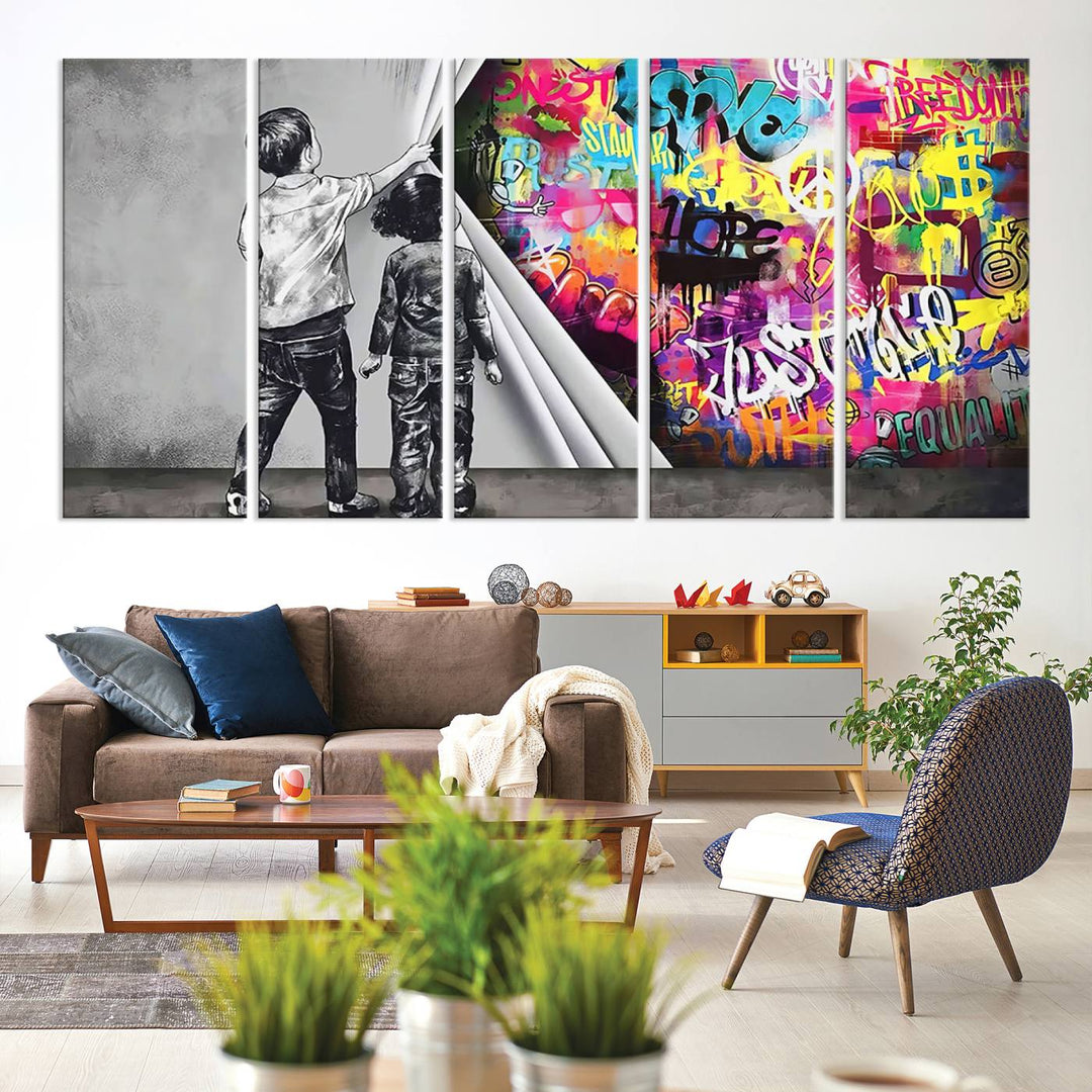 The Banksy Print - Street Art Canvas features a vibrant and bold image of two children lifting a curtain to reveal colorful graffiti. It's ready to hang, adding an urban modern decor vibe.