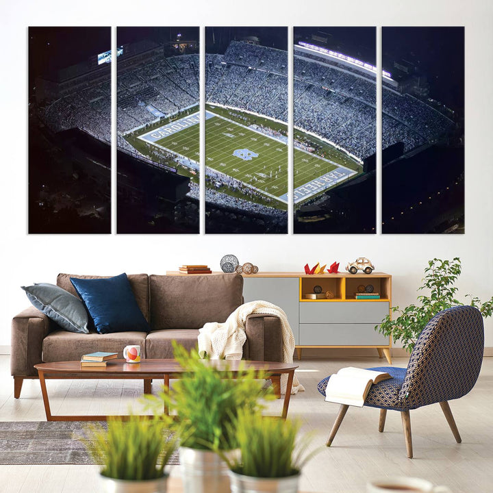 A University of North Carolina Tar Heels Football Team Print, showcasing Chapel Hill's Kenan Memorial Stadium, hangs in a modern dining room, adding a gallery-quality finish that enhances the entire space.