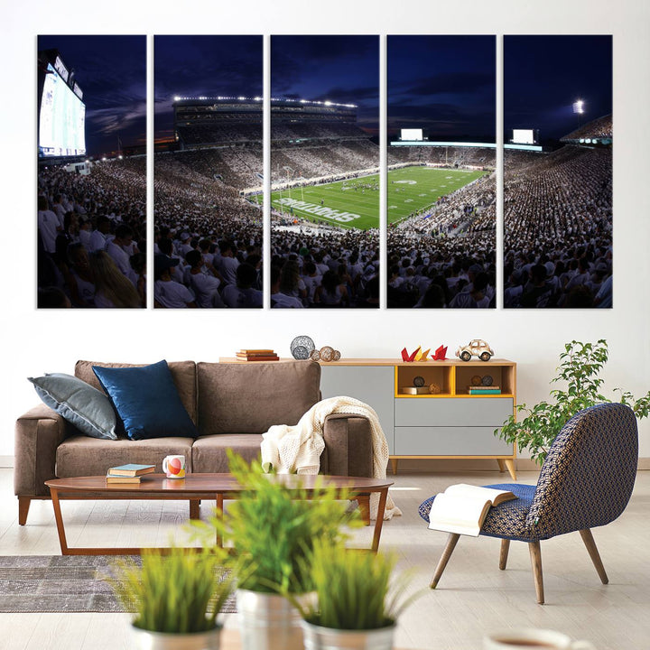 A packed football stadium at night, with bright lights and fans in white, depicted in a Michigan State Spartans Stadium wall art.