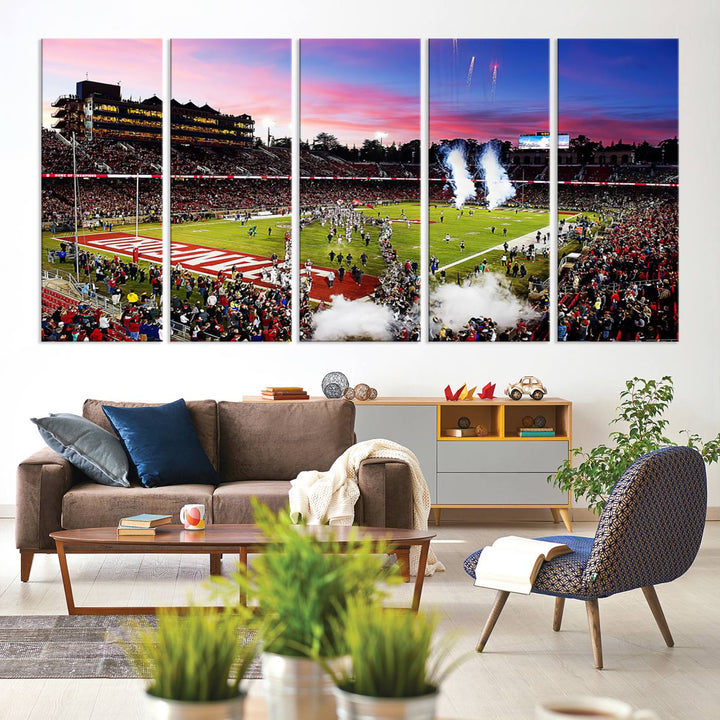 The wall art features a canvas print of the Stanford Cardinal football team, capturing players, fireworks, and smoke against the backdrop of a sunset at Stanford Stadium.