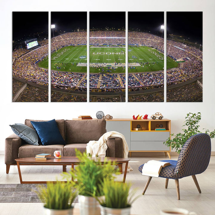 A large football stadium at night, featuring the UCONN Huskies, is depicted on the East Hartford Pratt & Whitney Stadium Wall Art Canvas Print.