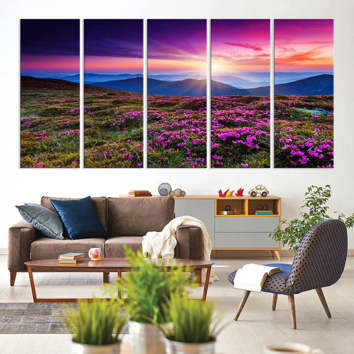 A 3-panel landscape photography canvas of a sunset over mountain meadows with purple wildflowers decorates the wall.