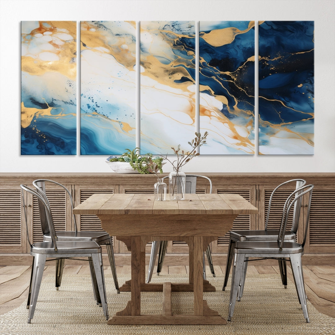 A modern living room featuring museum-quality Blue Gold Abstract Wall Art Print Contemporary art in a triptych arrangement.