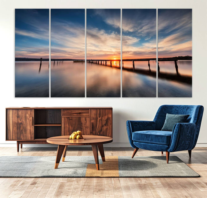 The Sunset Pier Canvas features a serene coastal landscape with vibrant hues under cloudy skies, ideal for modern decor.