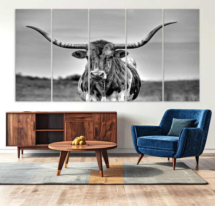 The Texas Longhorn Cow wall art, divided into three panels, is of gallery quality and displayed on a dark wall.