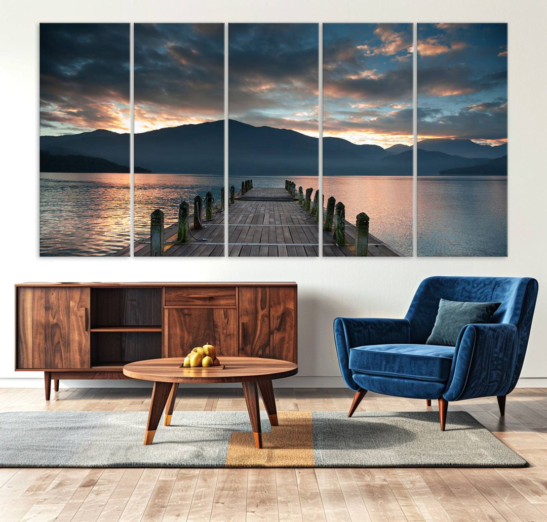 The Mountain Lake Wood Pier Canvas Wall Art depicts a serene lake and mountains, enhancing the beauty of any space.