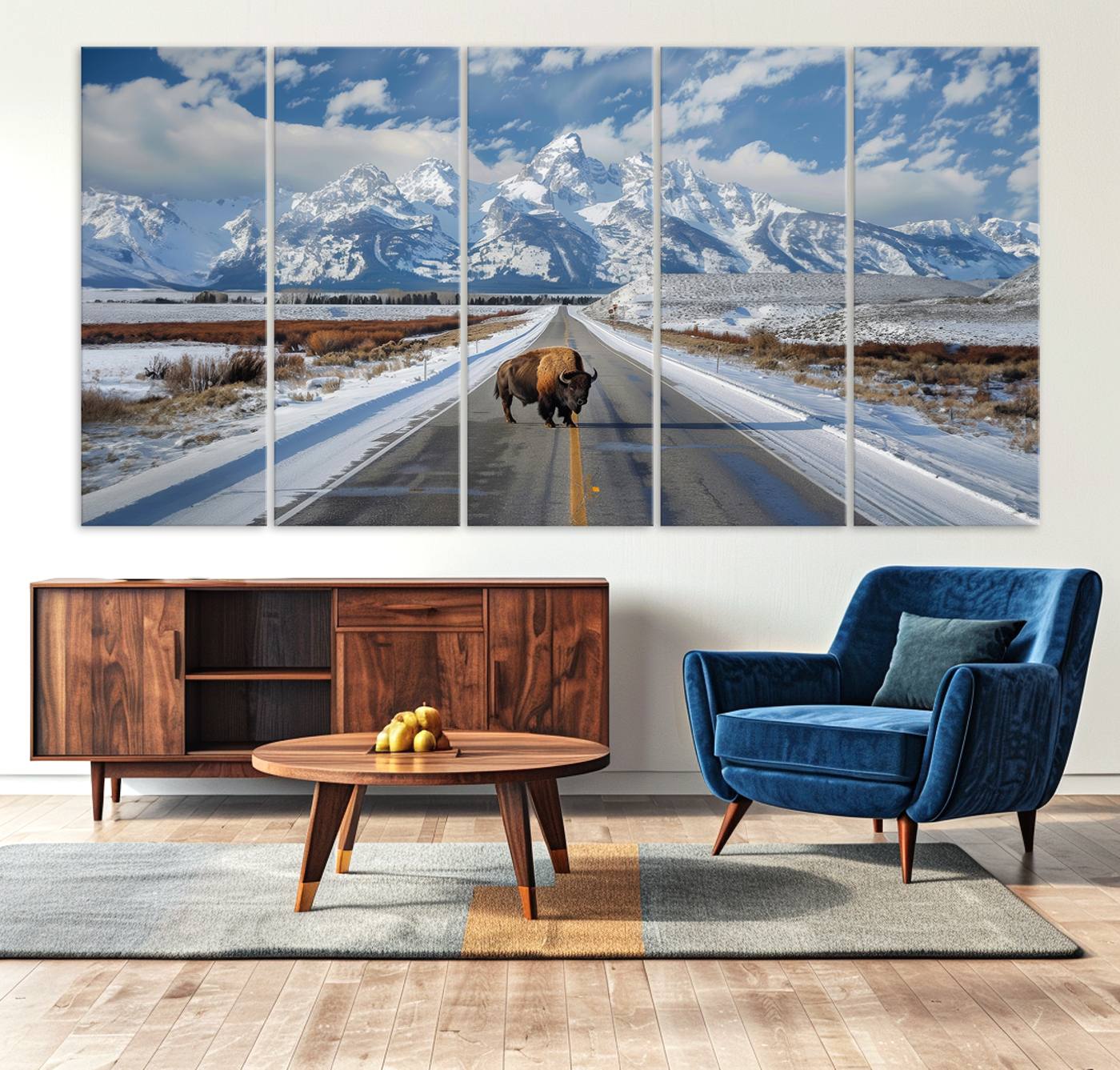 A powerful bison stands on a snow-dusted road beneath the towering peaks of the Grand Tetons, capturing the untamed beauty of America's winter wilderness.