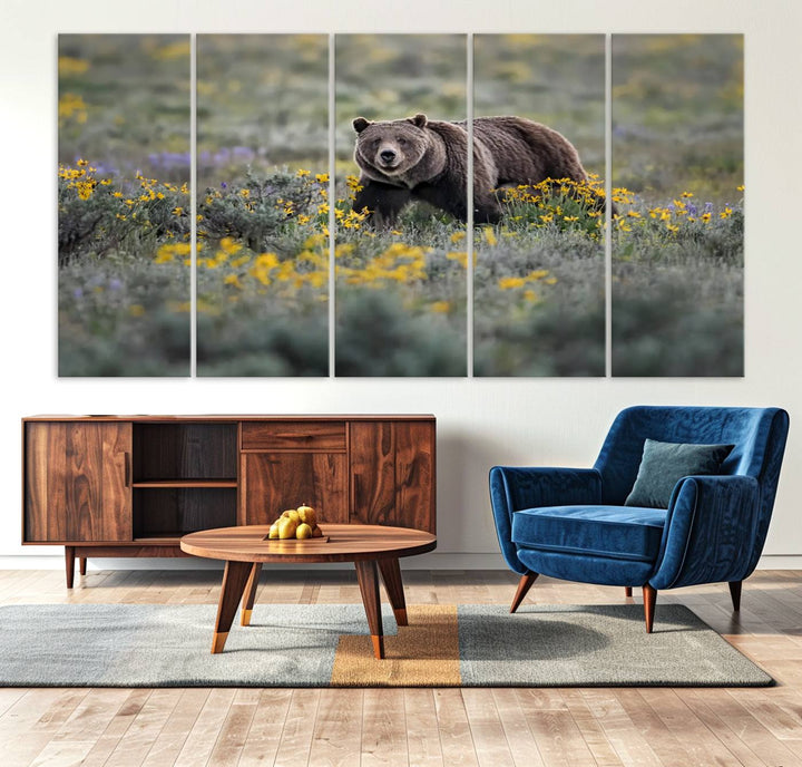 The "Grizzly 399 in Wild Flowers Wall Art Canvas Print" features a grizzly bear strolling through a field of yellow and purple flowers, beautifully showcased as a triptych. This handcrafted piece, proudly made in the USA, adds charm and sophistication to your space.