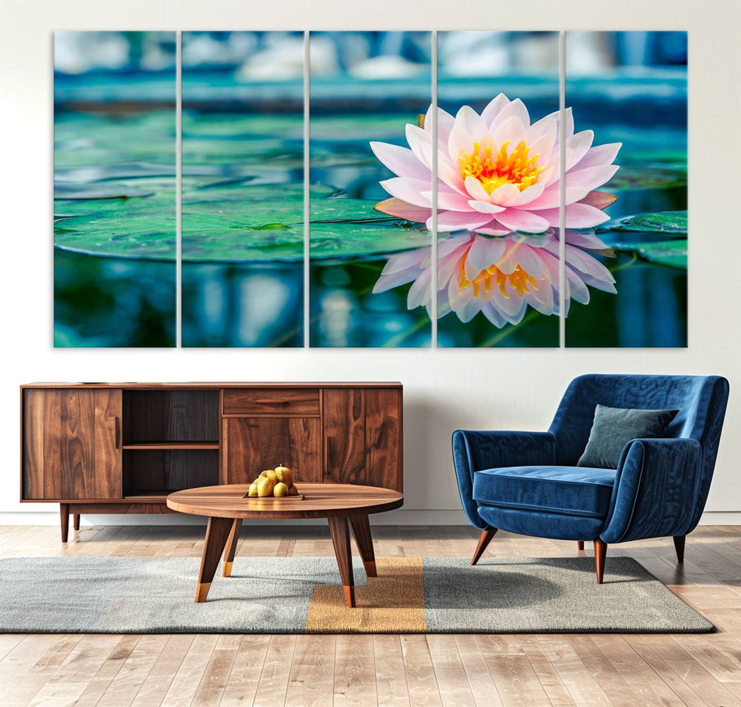 The Lotus Flower Canvas Print showcases a pink water lily with a yellow center gracefully floating on a calm pond.