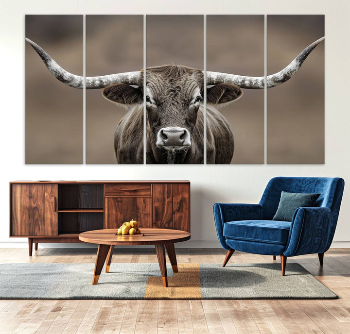 A close-up of a longhorn bull facing forward is featured in the Framed Texas Test-1, set against a blurred brown background.