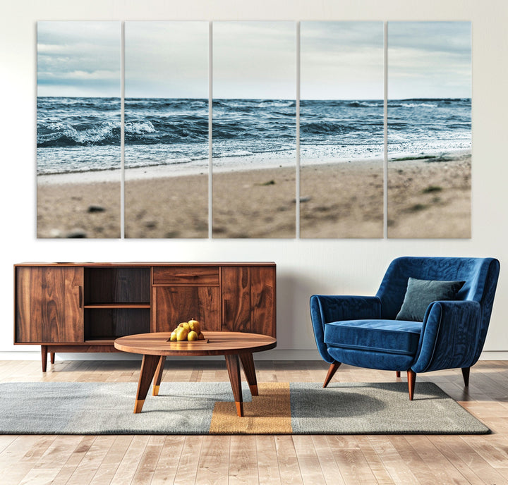 A moody ocean scene with gentle waves washing onto a sandy beach under a cloudy sky, creating a peaceful and coastal atmosphere.
