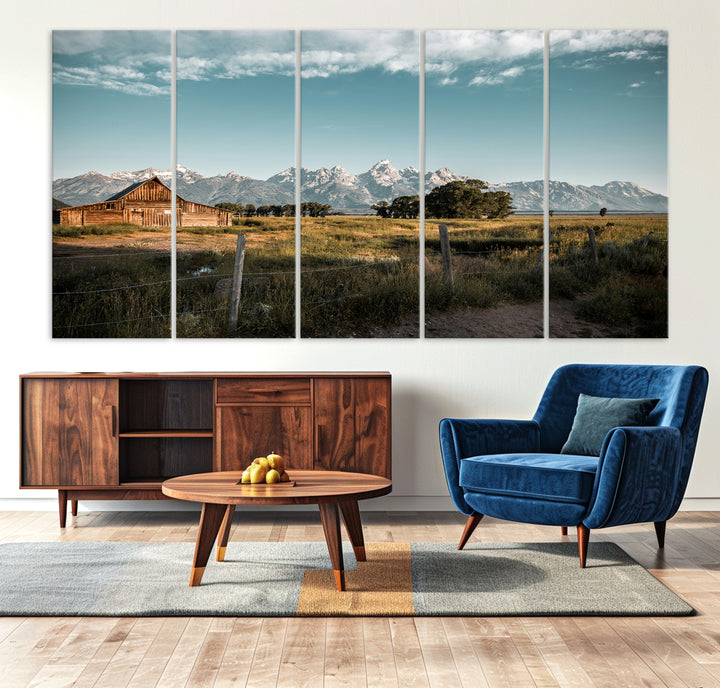 A rustic farmhouse with a wooden barn set against majestic mountain peaks under a soft blue sky, evoking peaceful countryside charm.