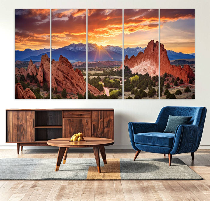 A vibrant sunset over the Rocky Mountains with red rocks.