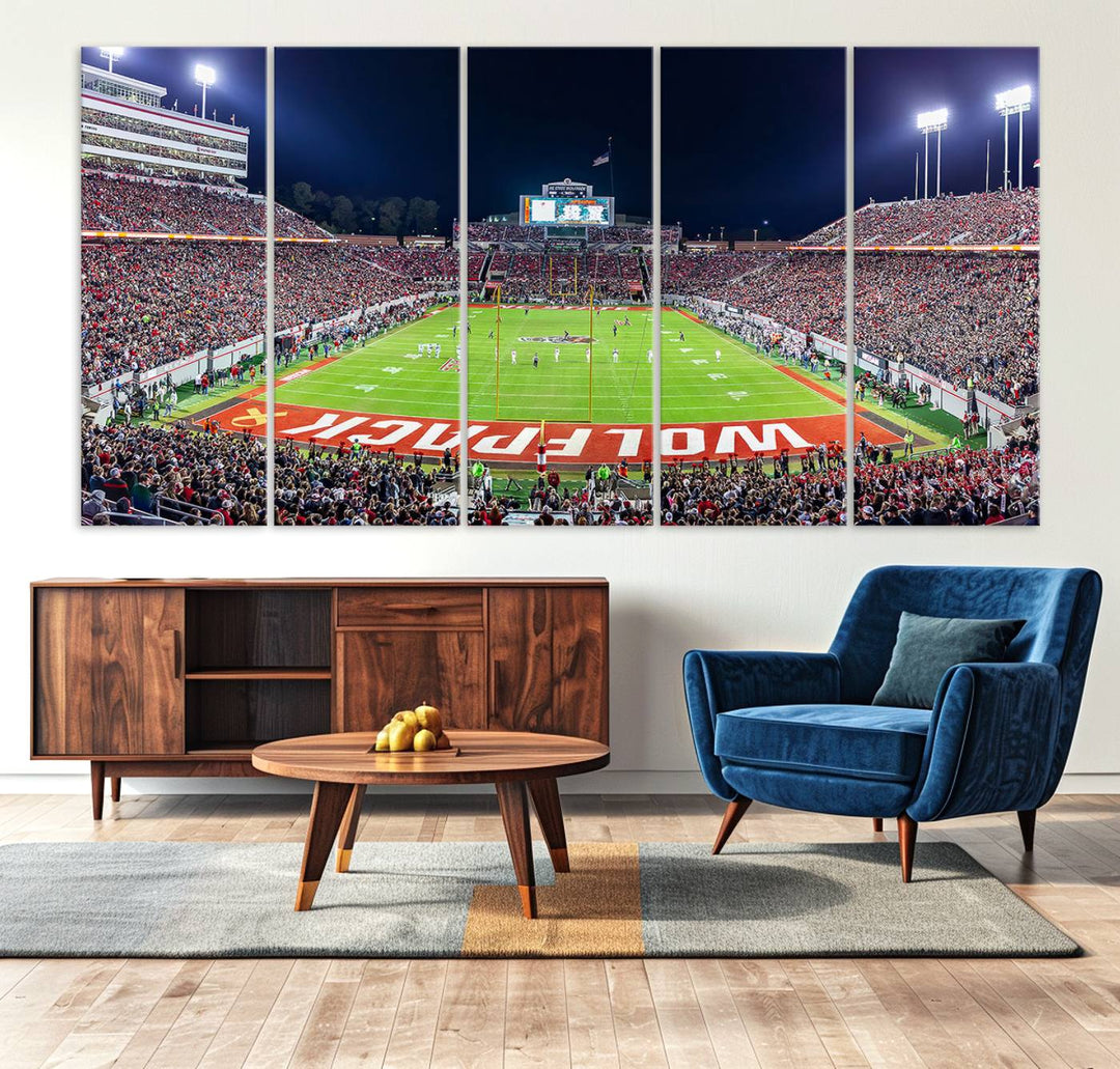 A NC State Wolfpack Football Team print of Carter-Finley Stadium at night features WOLFPACK illuminated brightly in the end zone grass.