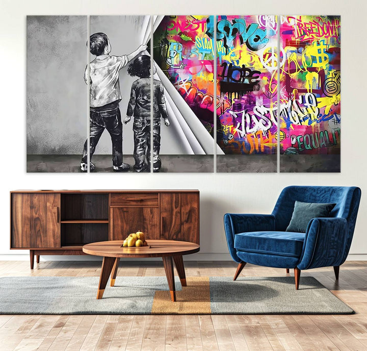 The Banksy Print - Street Art Canvas features a vibrant and bold image of two children lifting a curtain to reveal colorful graffiti. It's ready to hang, adding an urban modern decor vibe.