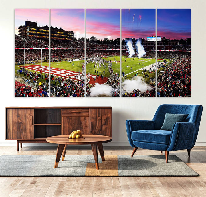 The wall art features a canvas print of the Stanford Cardinal football team, capturing players, fireworks, and smoke against the backdrop of a sunset at Stanford Stadium.