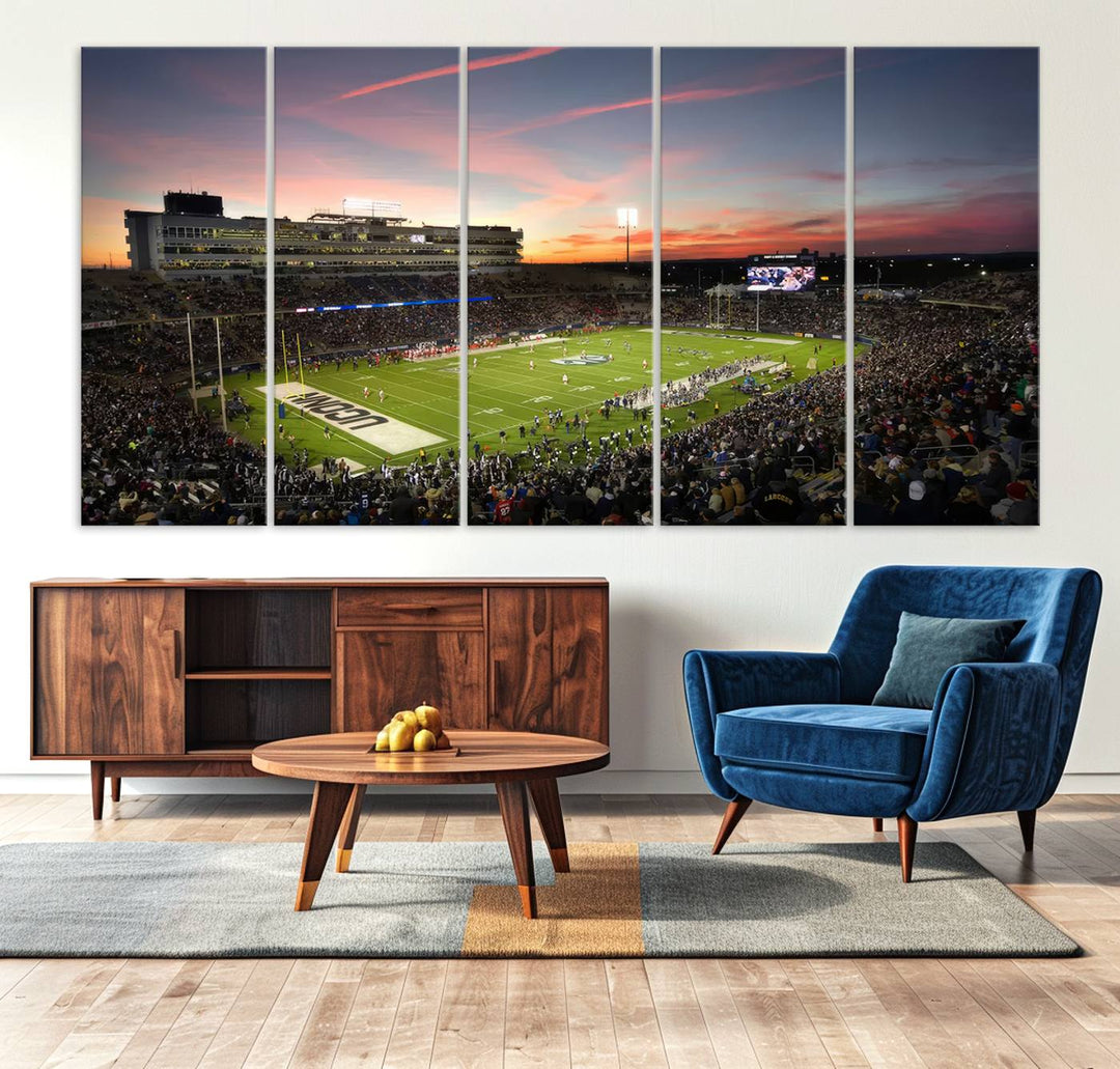 This wall art canvas print captures UCONN Huskies fans energizing a sunset scene at East Hartfords Pratt & Whitney Stadium.