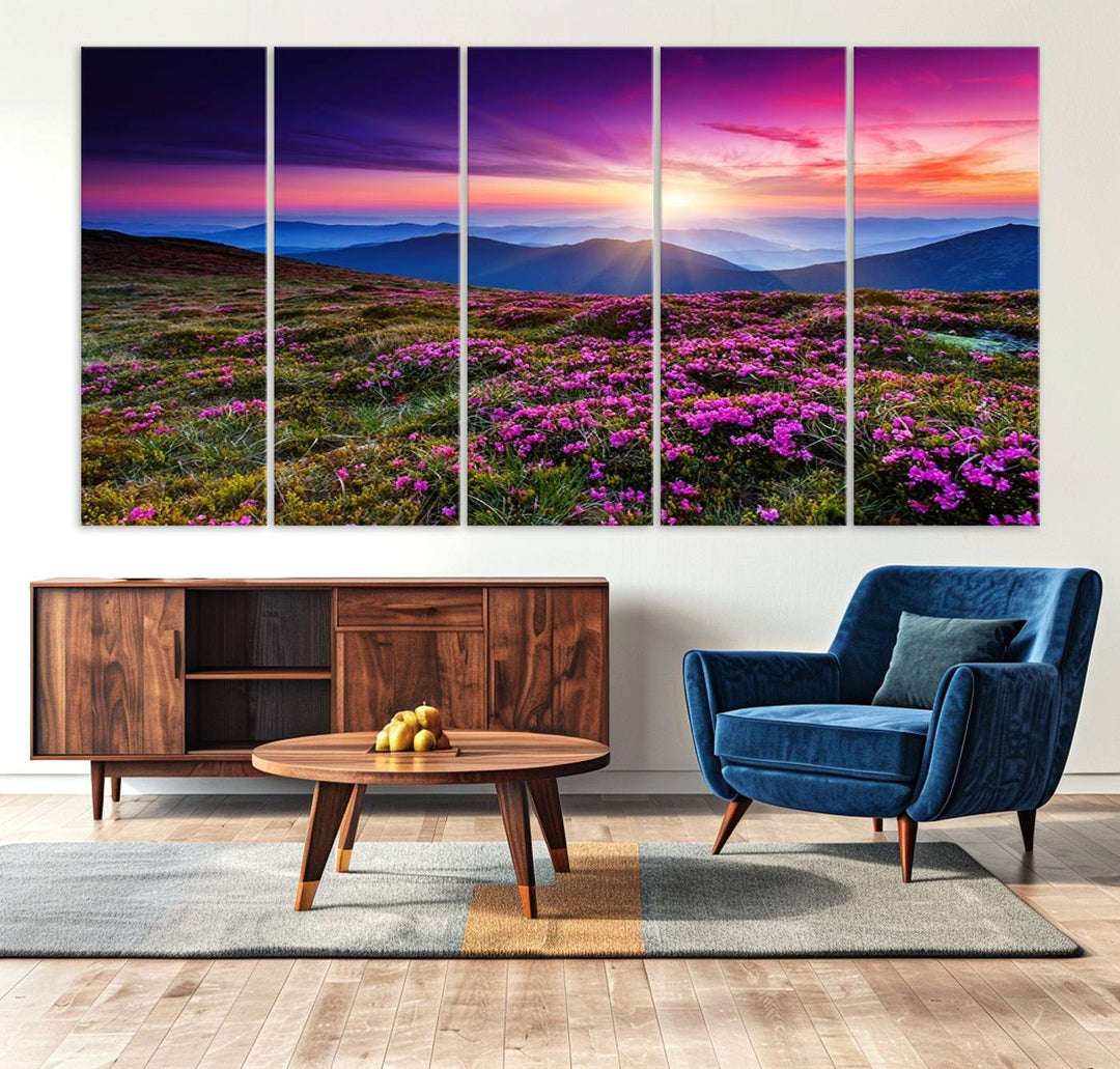 A 3-panel landscape photography canvas of a sunset over mountain meadows with purple wildflowers decorates the wall.