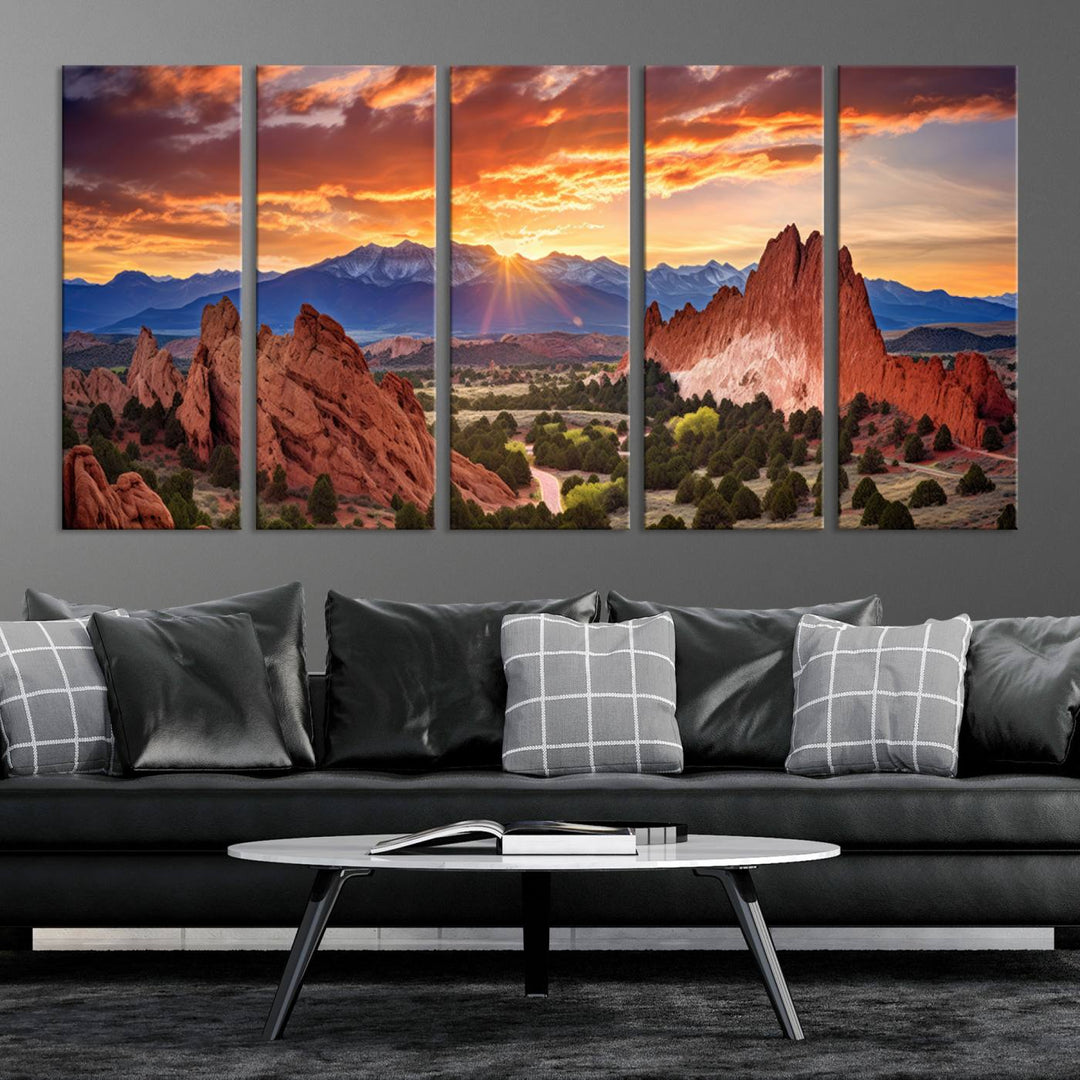 A vibrant sunset over the Rocky Mountains with red rocks.