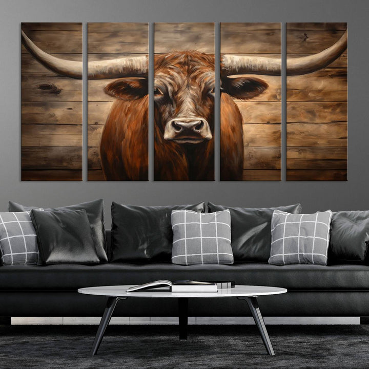 The Longhorn Bull Wall Art, a ready-to-hang canvas print, showcases an image of a brown longhorn cow set against a wooden background, perfect for those looking to enhance their space with rustic farmhouse and western barn decor.