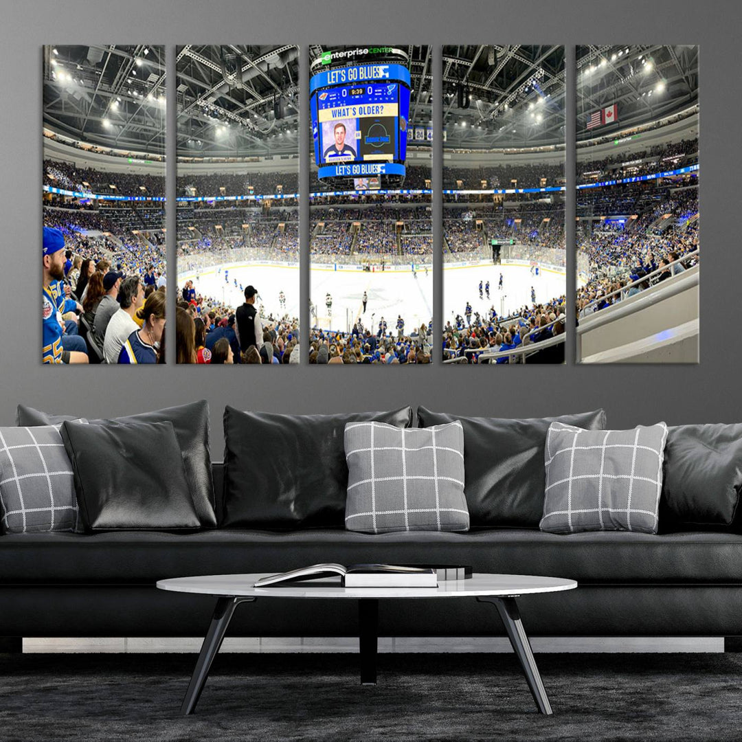 Wall art prints depicting the bustling scenes of the St. Louis Blues being cheered on by a full house at the Enterprise Center, beneath a large scoreboard.