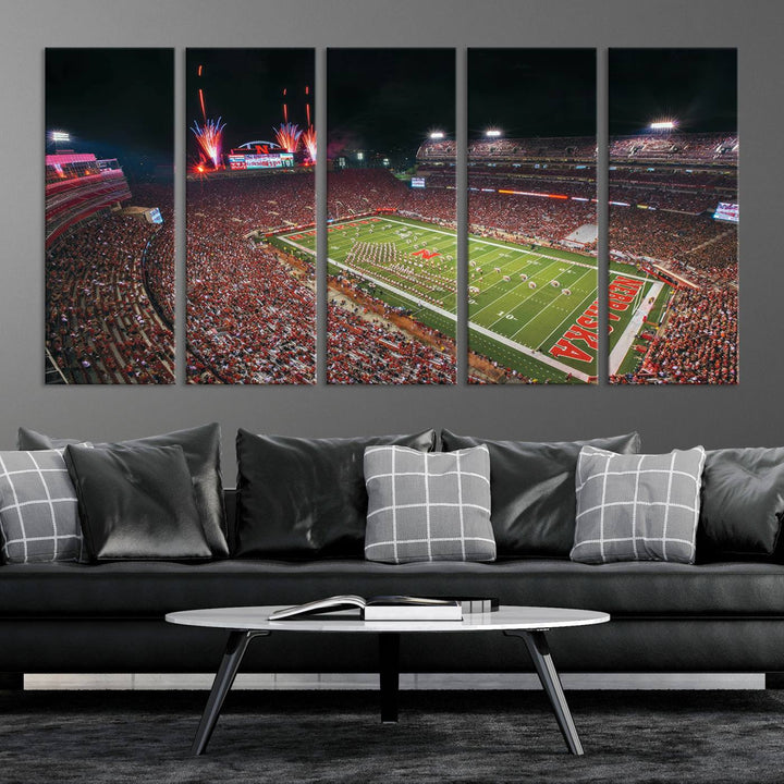 The University of Nebraska Cornhuskers Football Team Print, featuring Lincoln Memorial Stadium in a vibrant triptych canvas with fireworks above and a gallery-quality finish, is elegantly displayed.