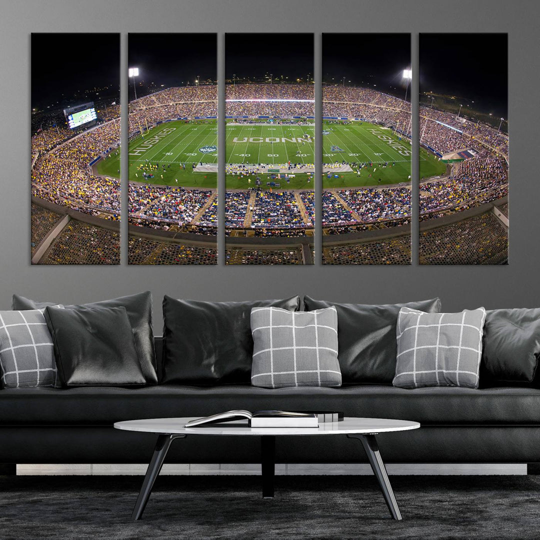 A large football stadium at night, featuring the UCONN Huskies, is depicted on the East Hartford Pratt & Whitney Stadium Wall Art Canvas Print.