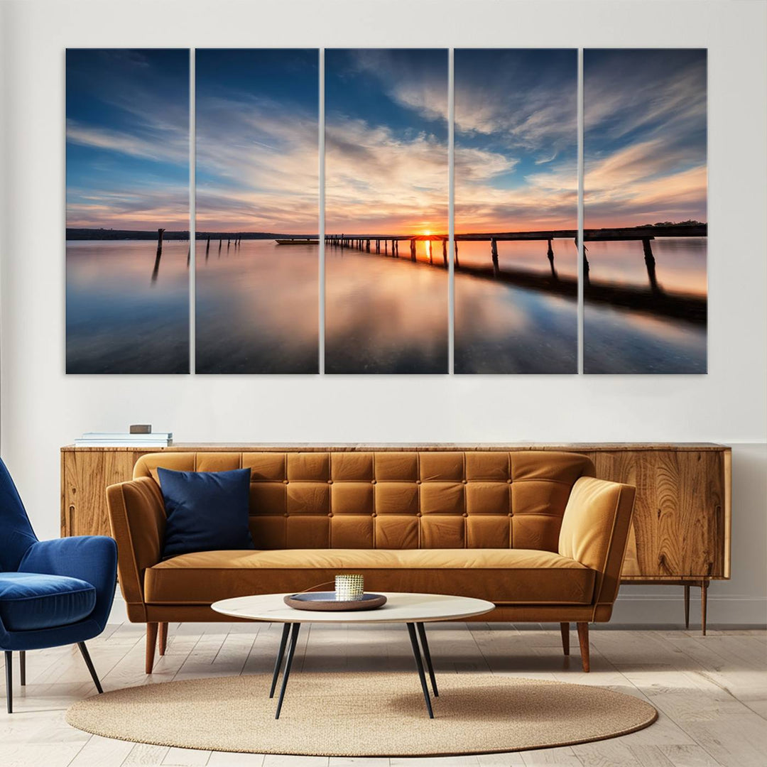 The Sunset Pier Canvas features a serene coastal landscape with vibrant hues under cloudy skies, ideal for modern decor.