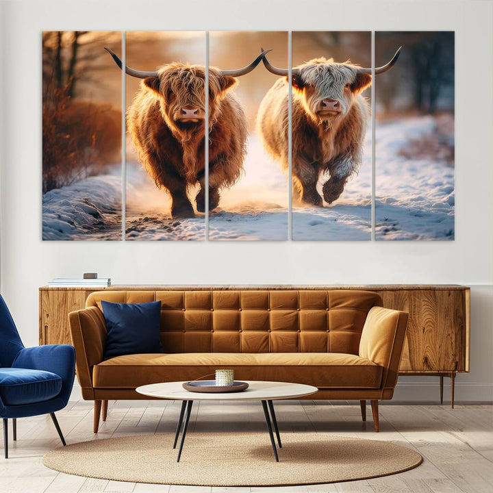 The wall art is a Scottish Highland Cow Horn canvas print featuring cows on a snowy path bathed in warm sunlight, serving as a rustic decor piece.