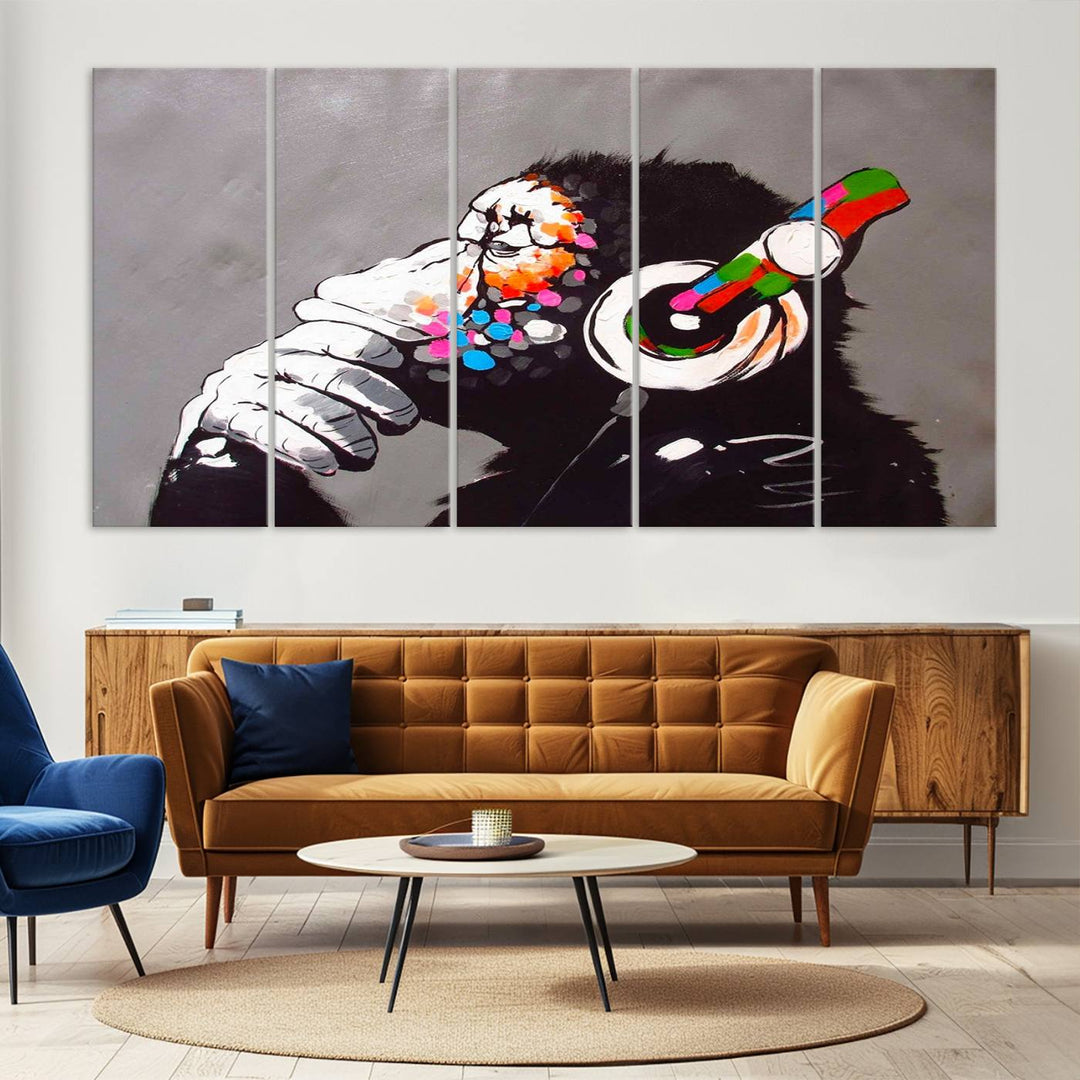 A vibrant triptych, the "DJ Monkey Listening to Music" wall art print, features a Banksy-inspired large canvas adorned with colorful modern pop art. This striking piece elegantly enhances the room with its dynamic and lively depiction.