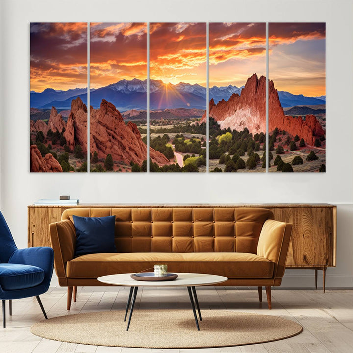A vibrant sunset over the Rocky Mountains with red rocks.