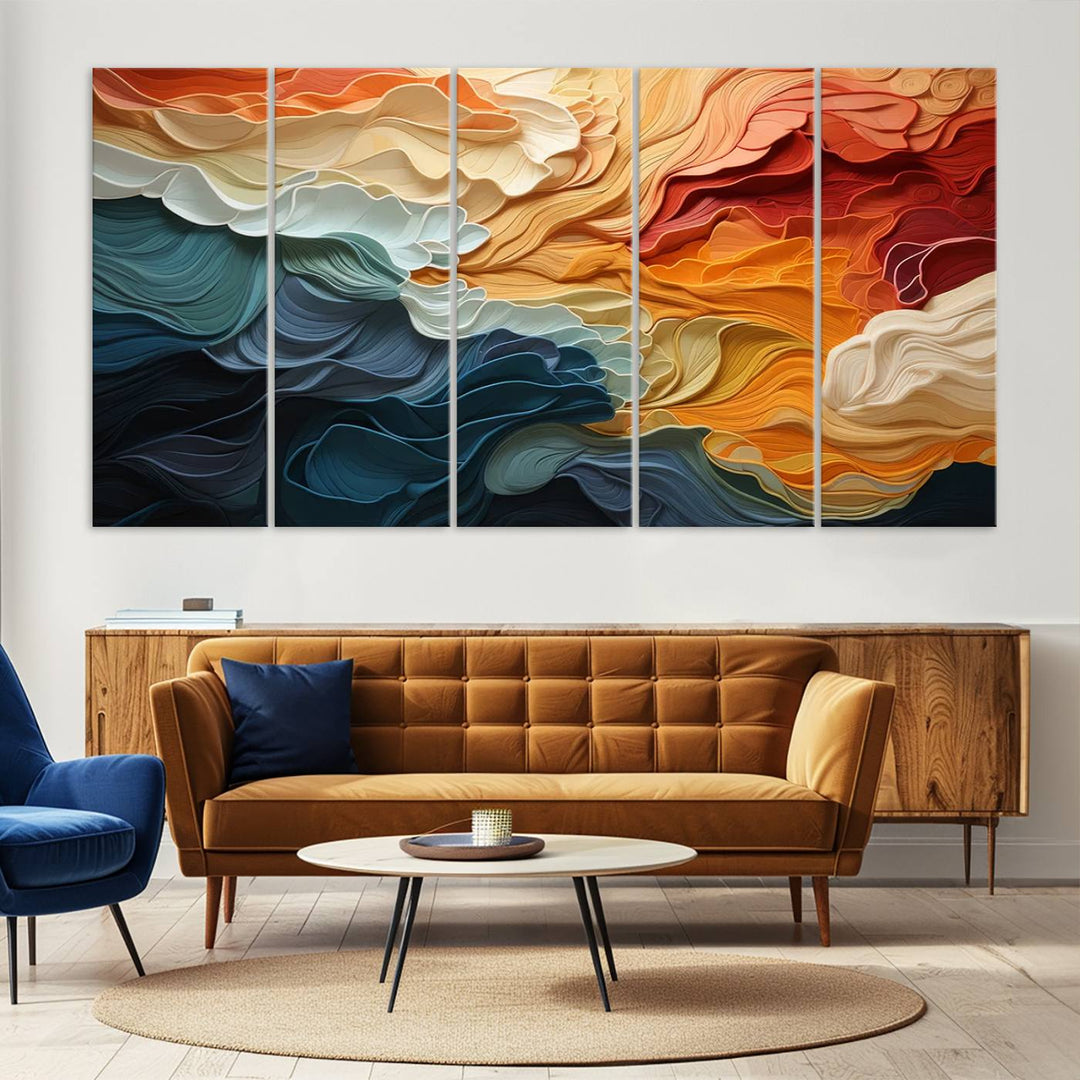 A Blue Orange Abstract Wave Wall Art Canvas Print adorns the wall. This colorful masterpiece is professionally hand-assembled to enhance any space.