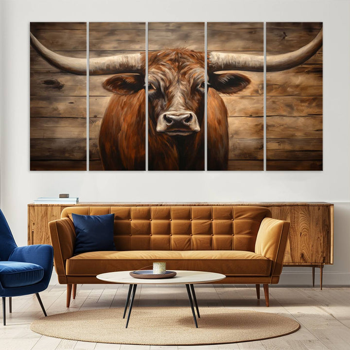 The Longhorn Bull Wall Art, a ready-to-hang canvas print, showcases an image of a brown longhorn cow set against a wooden background, perfect for those looking to enhance their space with rustic farmhouse and western barn decor.