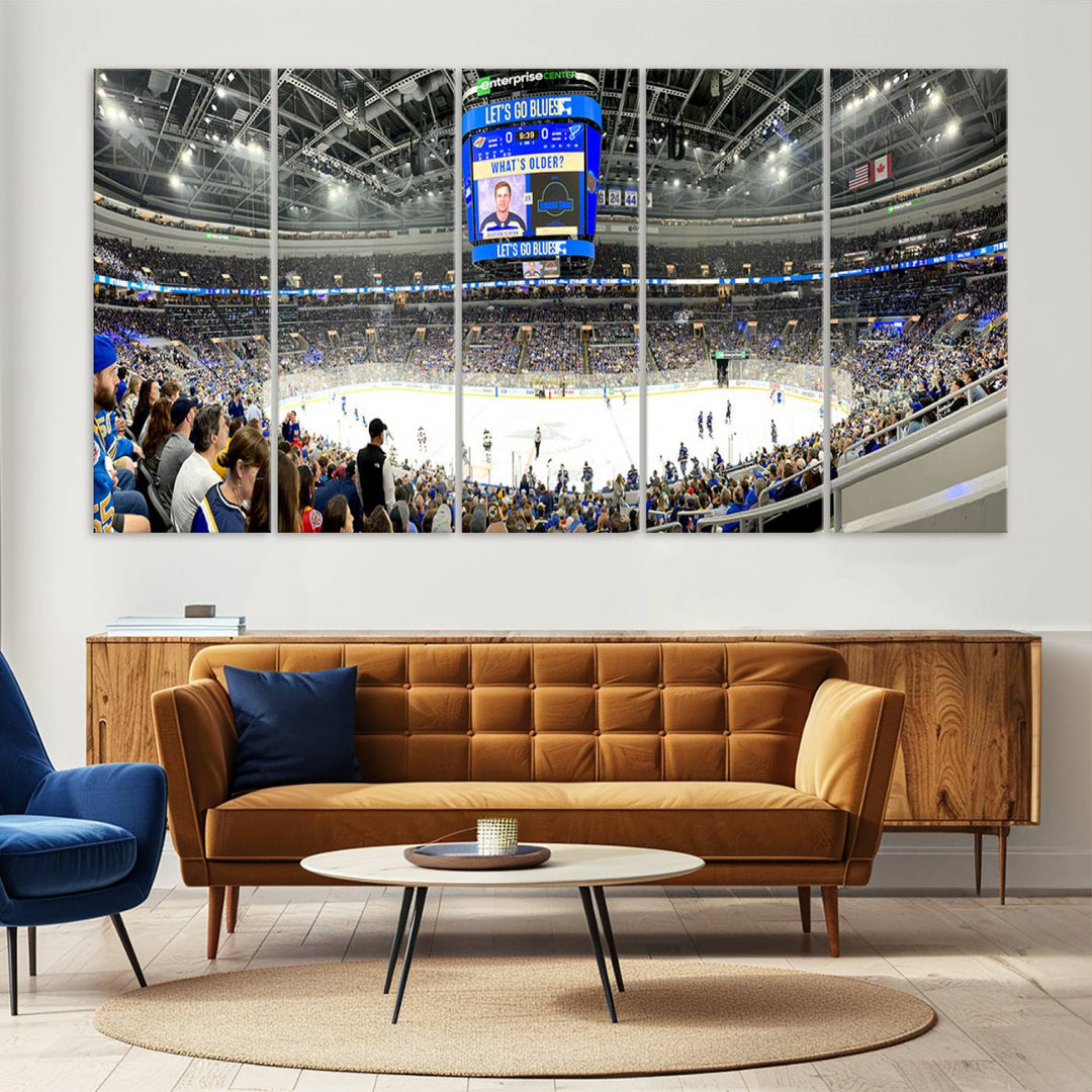 Wall art prints depicting the bustling scenes of the St. Louis Blues being cheered on by a full house at the Enterprise Center, beneath a large scoreboard.