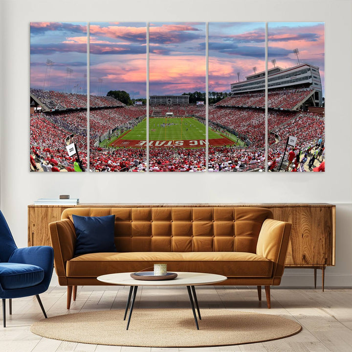 The wall art captures an NC State Wolfpack game under a vibrant sunset on triple canvas.