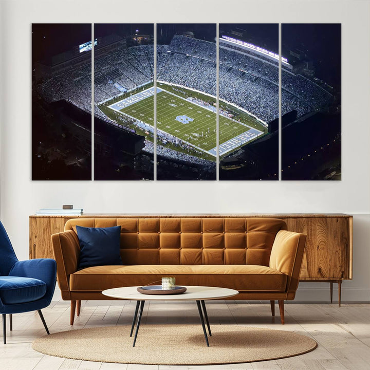 A University of North Carolina Tar Heels Football Team Print, showcasing Chapel Hill's Kenan Memorial Stadium, hangs in a modern dining room, adding a gallery-quality finish that enhances the entire space.