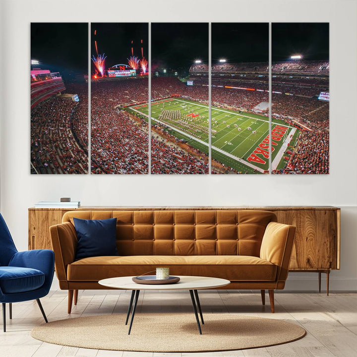 The University of Nebraska Cornhuskers Football Team Print, featuring Lincoln Memorial Stadium in a vibrant triptych canvas with fireworks above and a gallery-quality finish, is elegantly displayed.