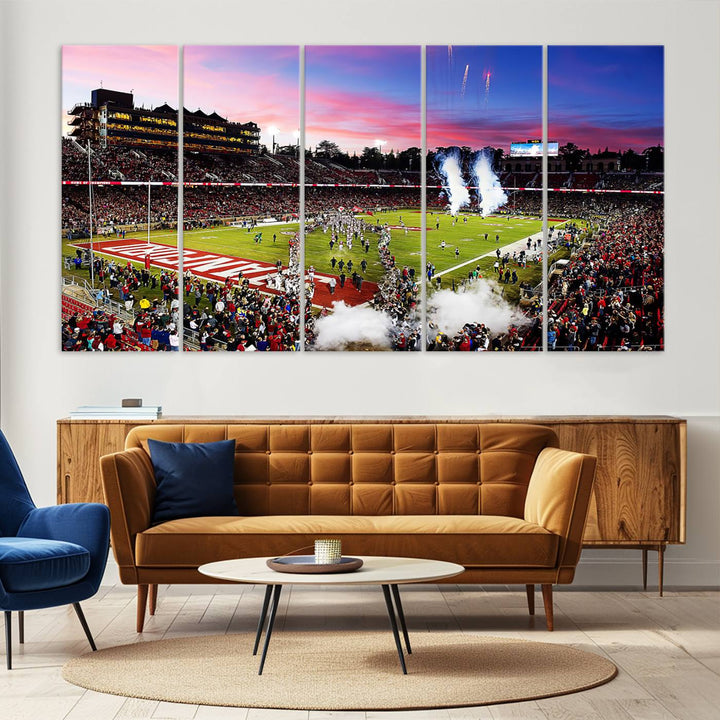 The wall art features a canvas print of the Stanford Cardinal football team, capturing players, fireworks, and smoke against the backdrop of a sunset at Stanford Stadium.