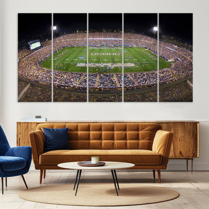 A large football stadium at night, featuring the UCONN Huskies, is depicted on the East Hartford Pratt & Whitney Stadium Wall Art Canvas Print.