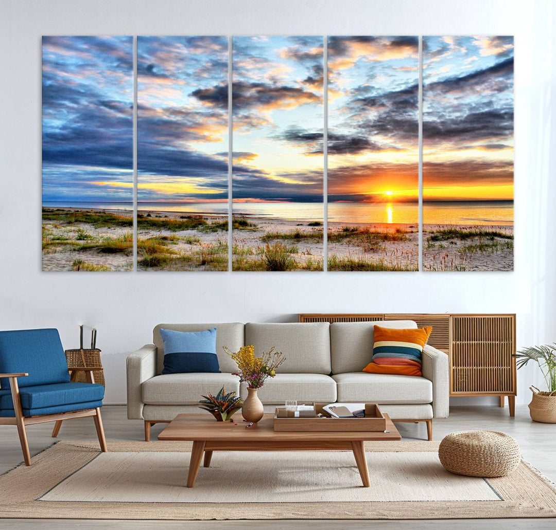 The Sunset On The Ocean canvas wall art features a beautiful beach sunset with grass and clouds.