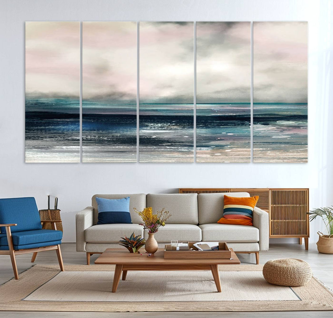 A contemporary abstract wall art canvas print in pastel pink, teal, and gray tones hangs on the wall.