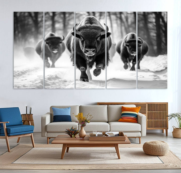 The Buffalo Wall Art Canvas Print of bison running through snow adorns the wall.