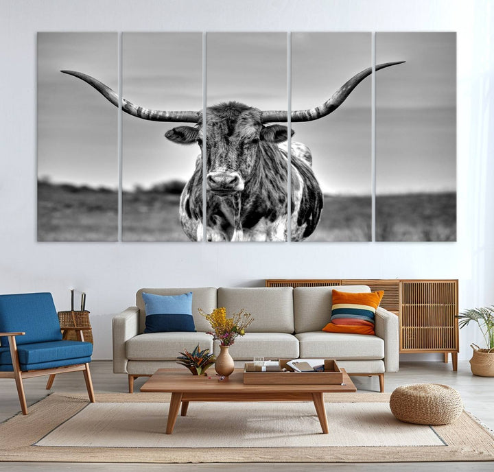 The Texas Longhorn Cow wall art, divided into three panels, is of gallery quality and displayed on a dark wall.