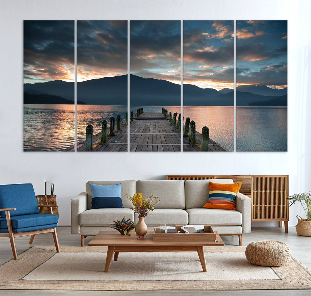 The Mountain Lake Wood Pier Canvas Wall Art depicts a serene lake and mountains, enhancing the beauty of any space.