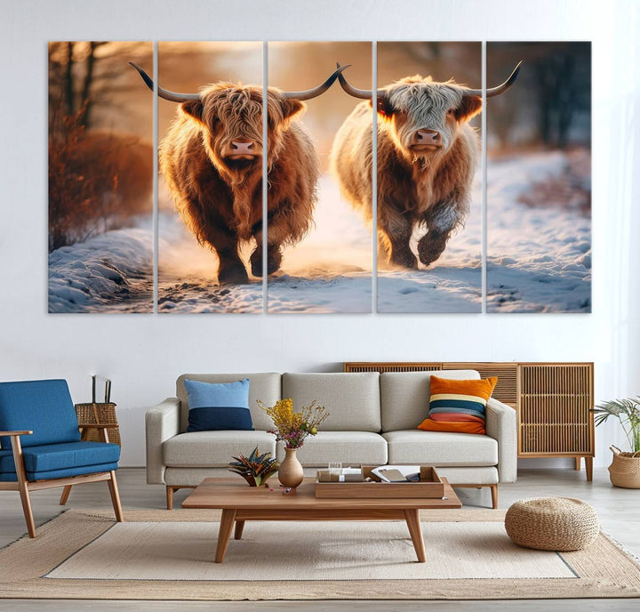 The wall art is a Scottish Highland Cow Horn canvas print featuring cows on a snowy path bathed in warm sunlight, serving as a rustic decor piece.