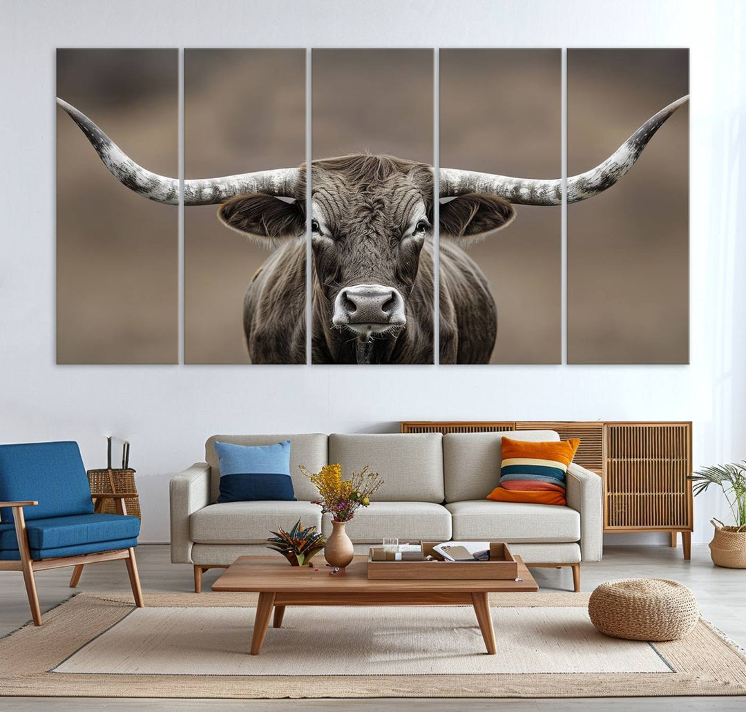 A close-up of a longhorn bull facing forward is featured in the Framed Texas Test-1, set against a blurred brown background.