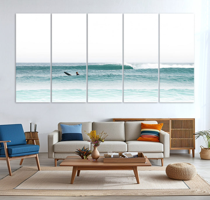 Minimalist photo of a lone surfer on calm aqua waves under bright sky, perfect for Scandinavian coastal or serene ocean-inspired home decor.